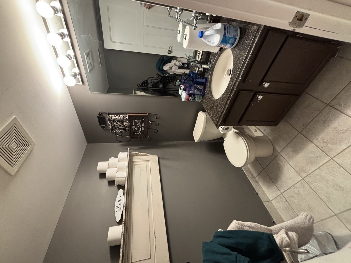 Before — outdated bathroom with dark vanity